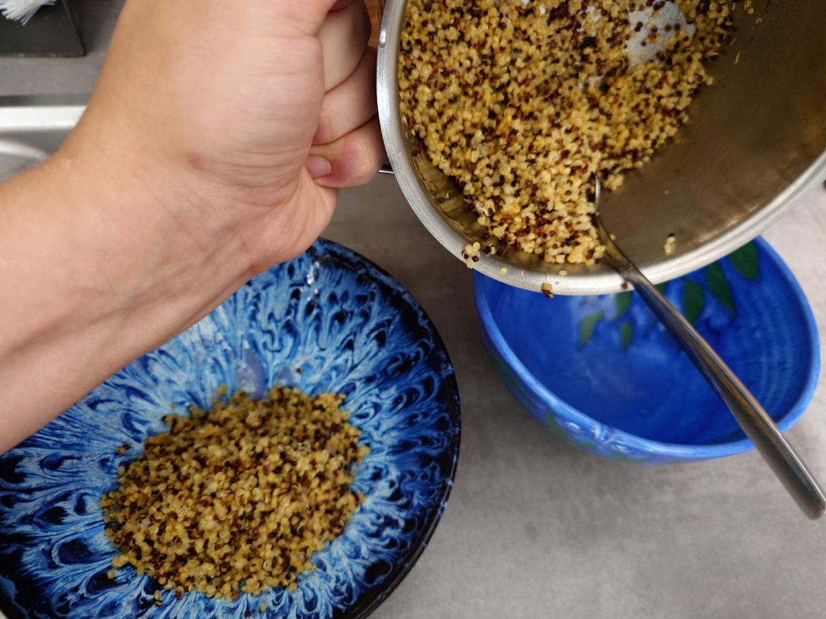 Quinoa spooned into the bowls
