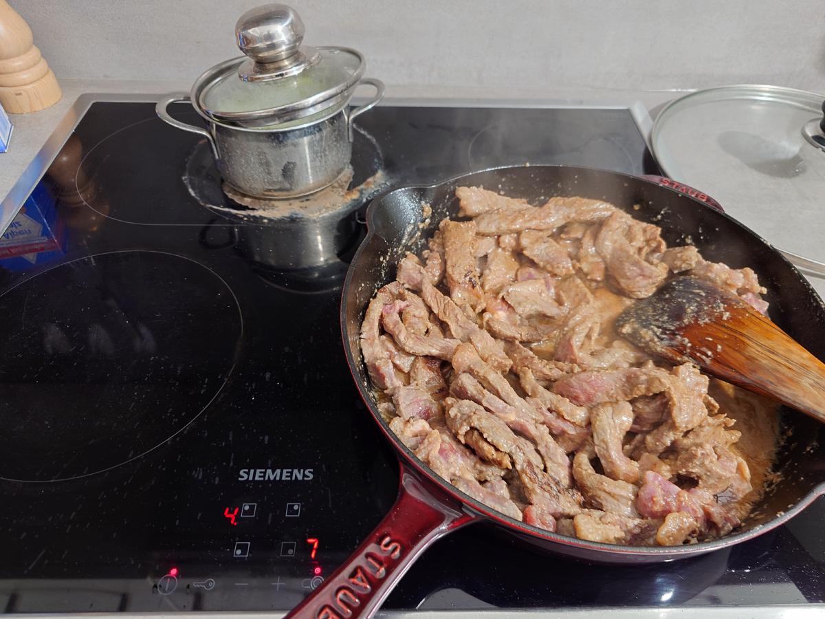 Beef stirred in its own liquid, heat backed off