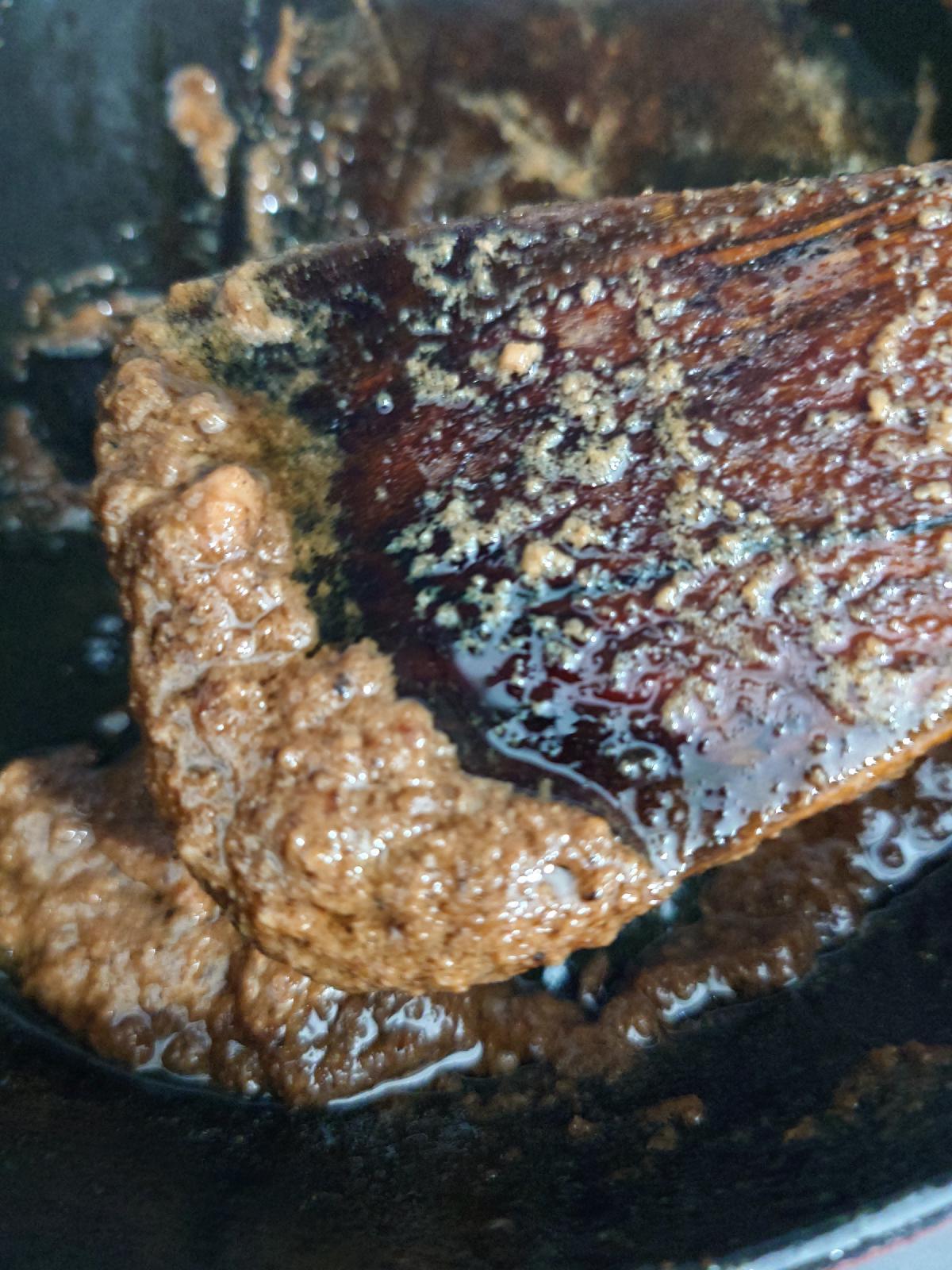 Reduced to a dark glaze on the spatula