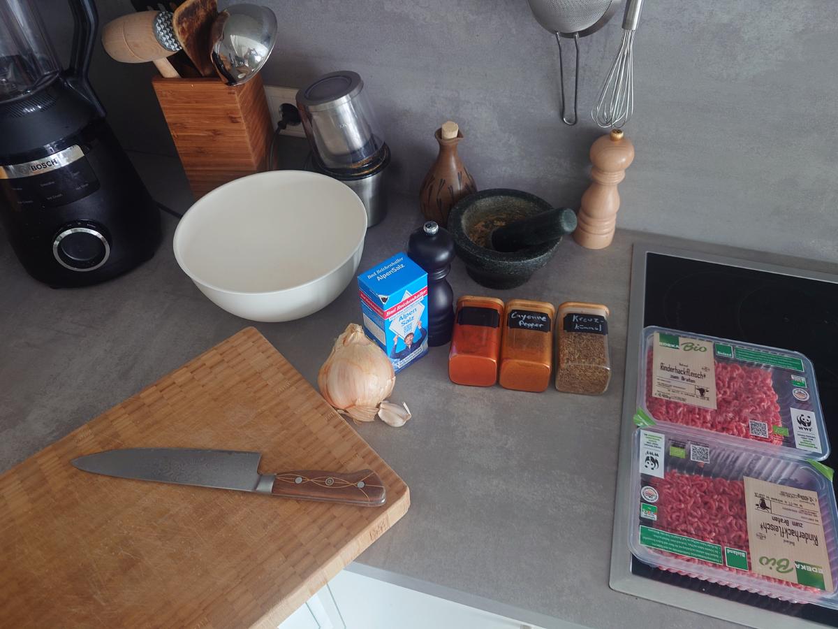 Beef, onion, garlic and spices set out on the counter