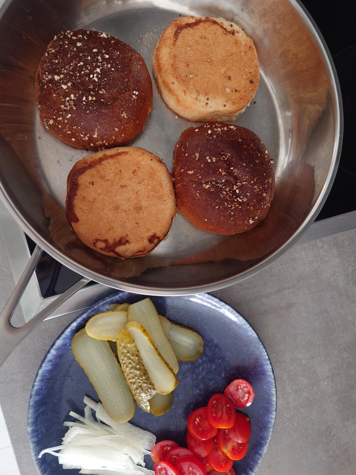 The toasted buns and the plate of toppings