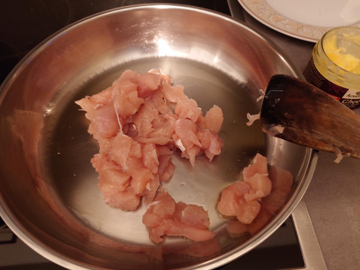The first batch of chicken laid out in the pan with space between pieces