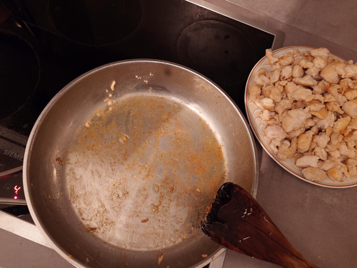 The emptied pan, brown fond across the base, all the chicken on the plate