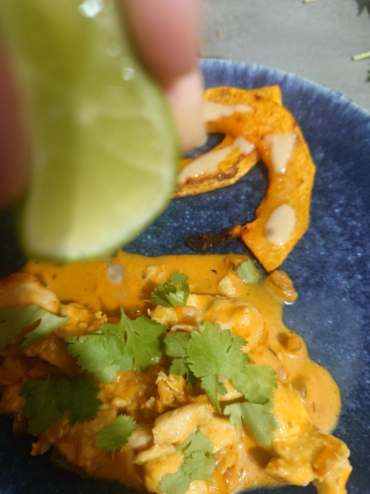 Lime squeezed over the plated chicken and squash