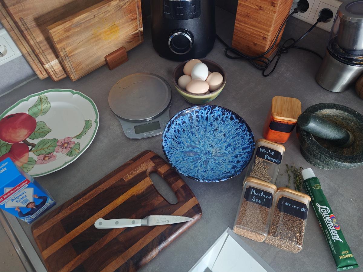 Eggs, scale, mortar and spice jars set out on the counter