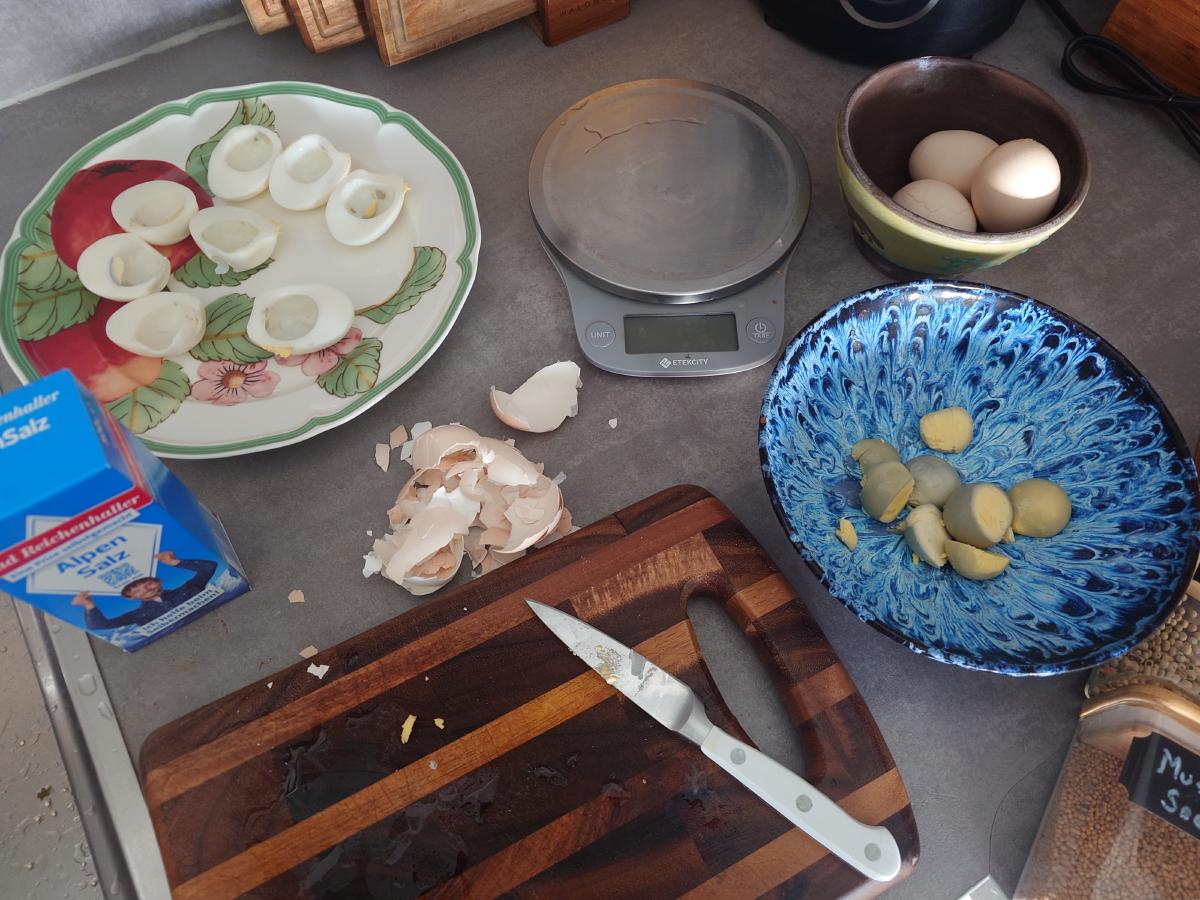 Halved whites on the plate, yolks and shells alongside