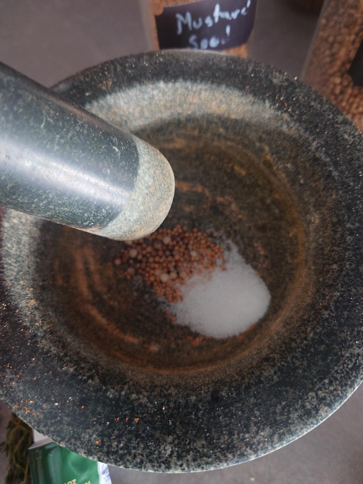 Mustard seeds and salt in the mortar