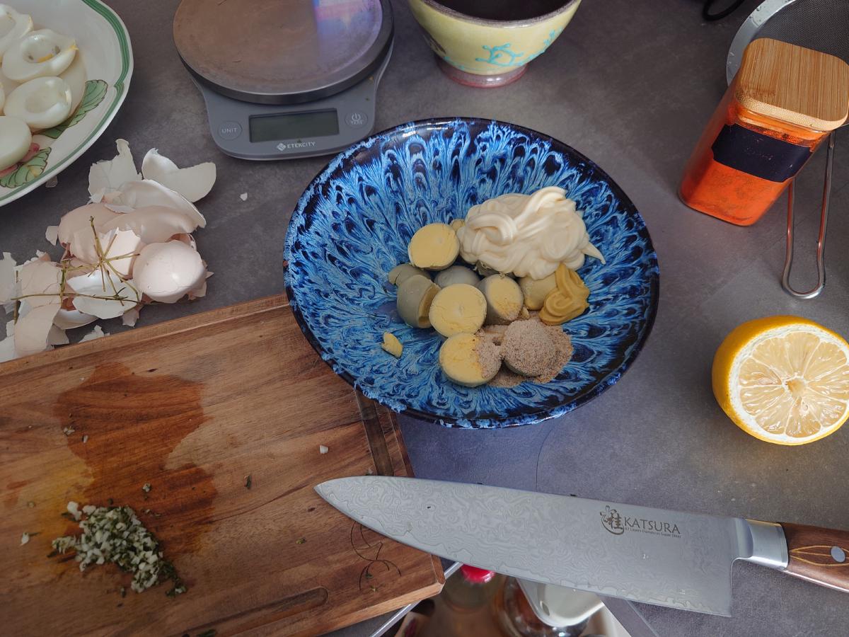 Mayonnaise, mustard and the ground spices over the yolks