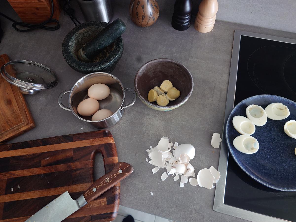 Halving the eggs, yolks into the bowl