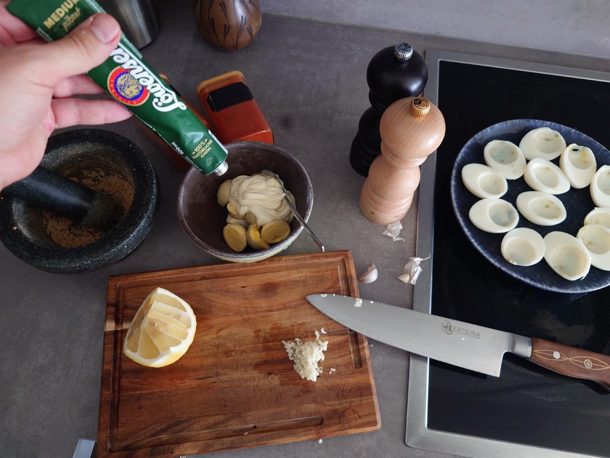Mustard squeezed in over the yolks and mayonnaise