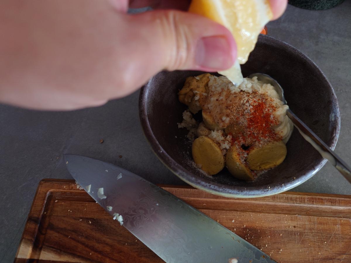 A squeeze of lemon into the bowl