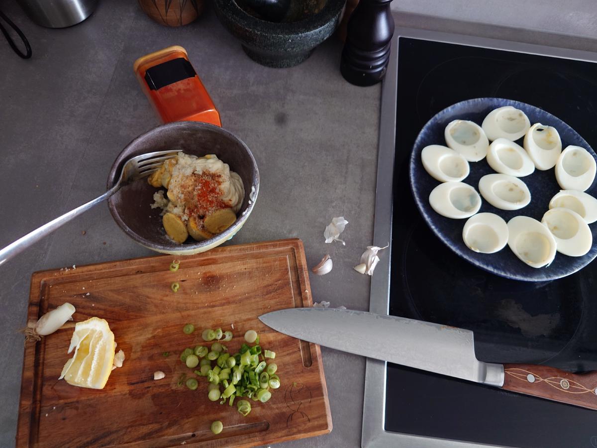 The filling mashed, spring onion sliced on the board