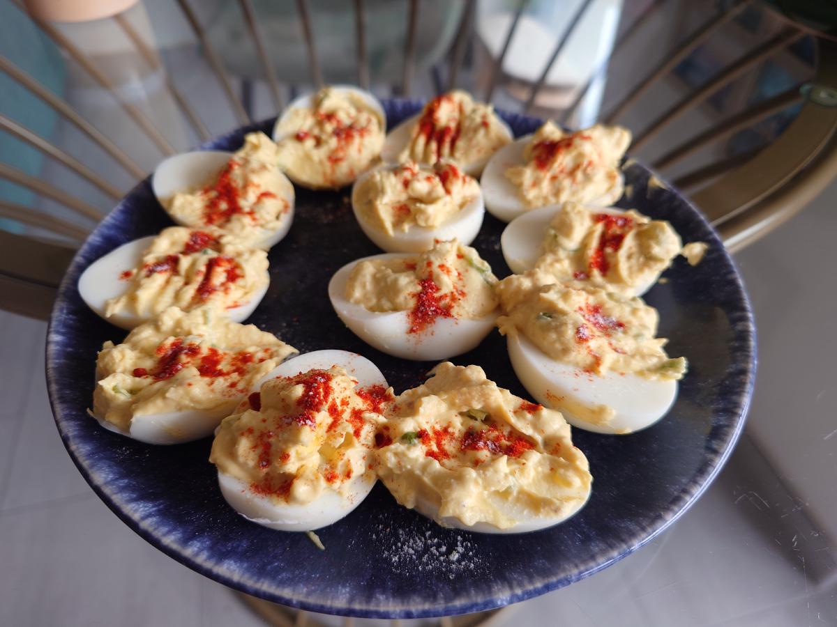 The finished deviled eggs on the blue plate