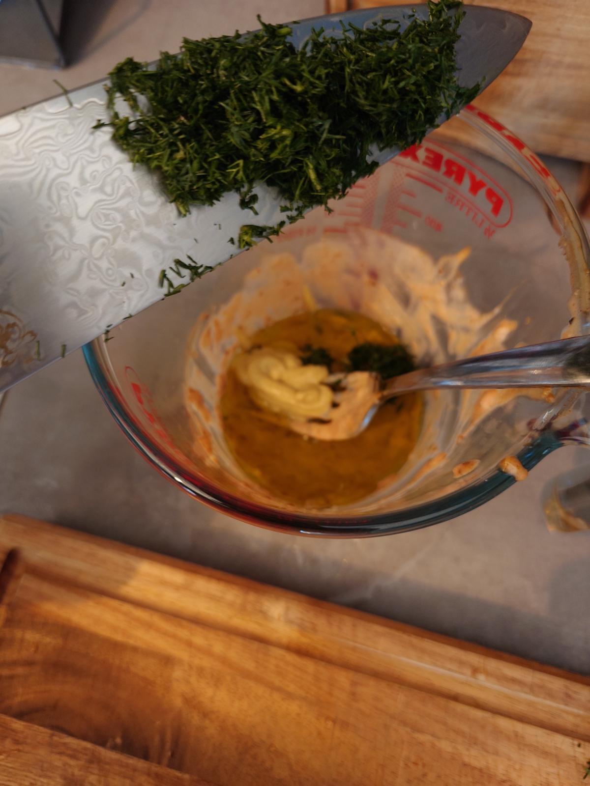Chopped dill going into the cup