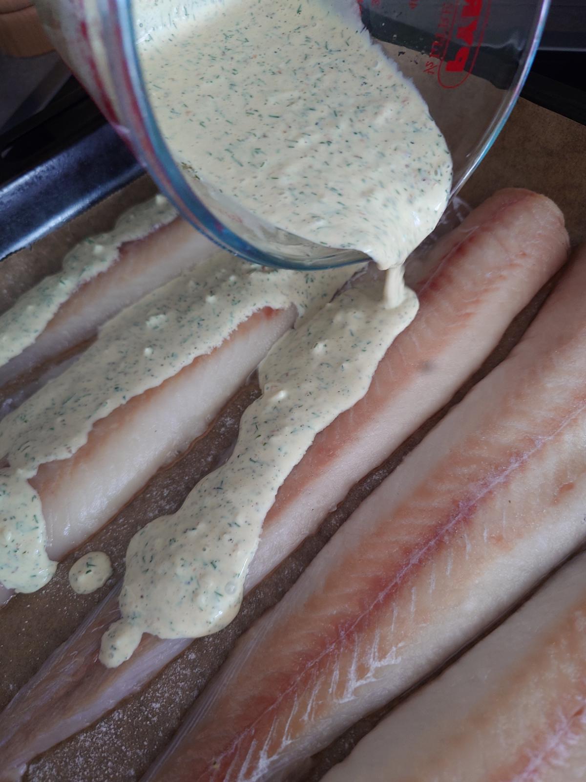 The thin sauce poured over the fillets, running off onto the tray