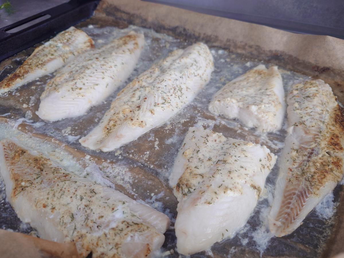 The baked fillets, coating dried to a thin speckled crust