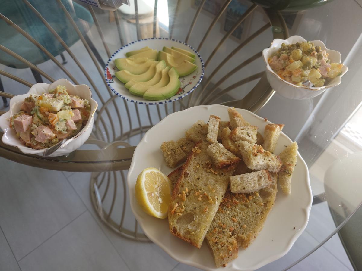 The toast cut up and plated with salad and avocado