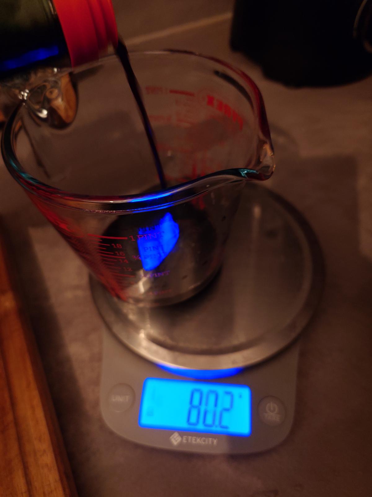 Dark tamari poured into a Pyrex jug on the scale