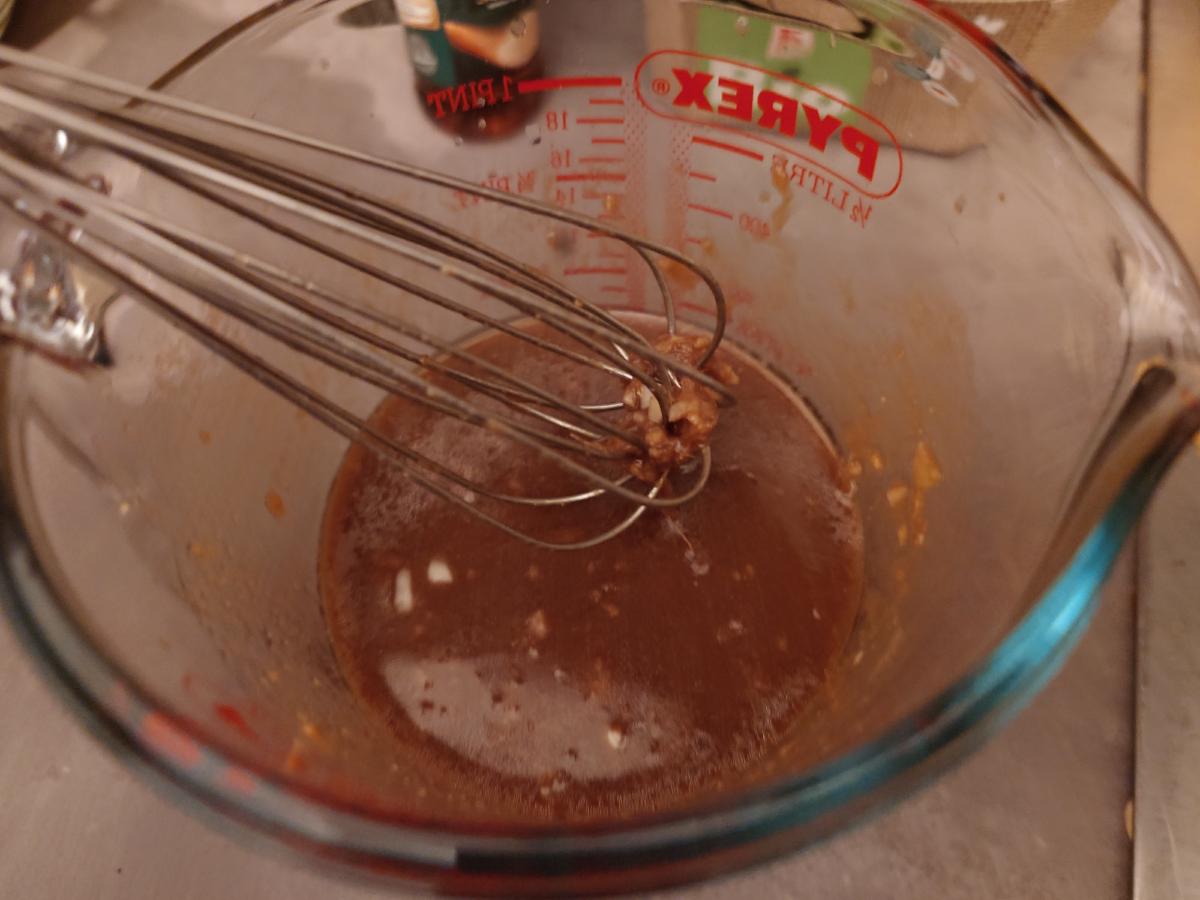 The marinade whisked smooth, pale brown in the jug