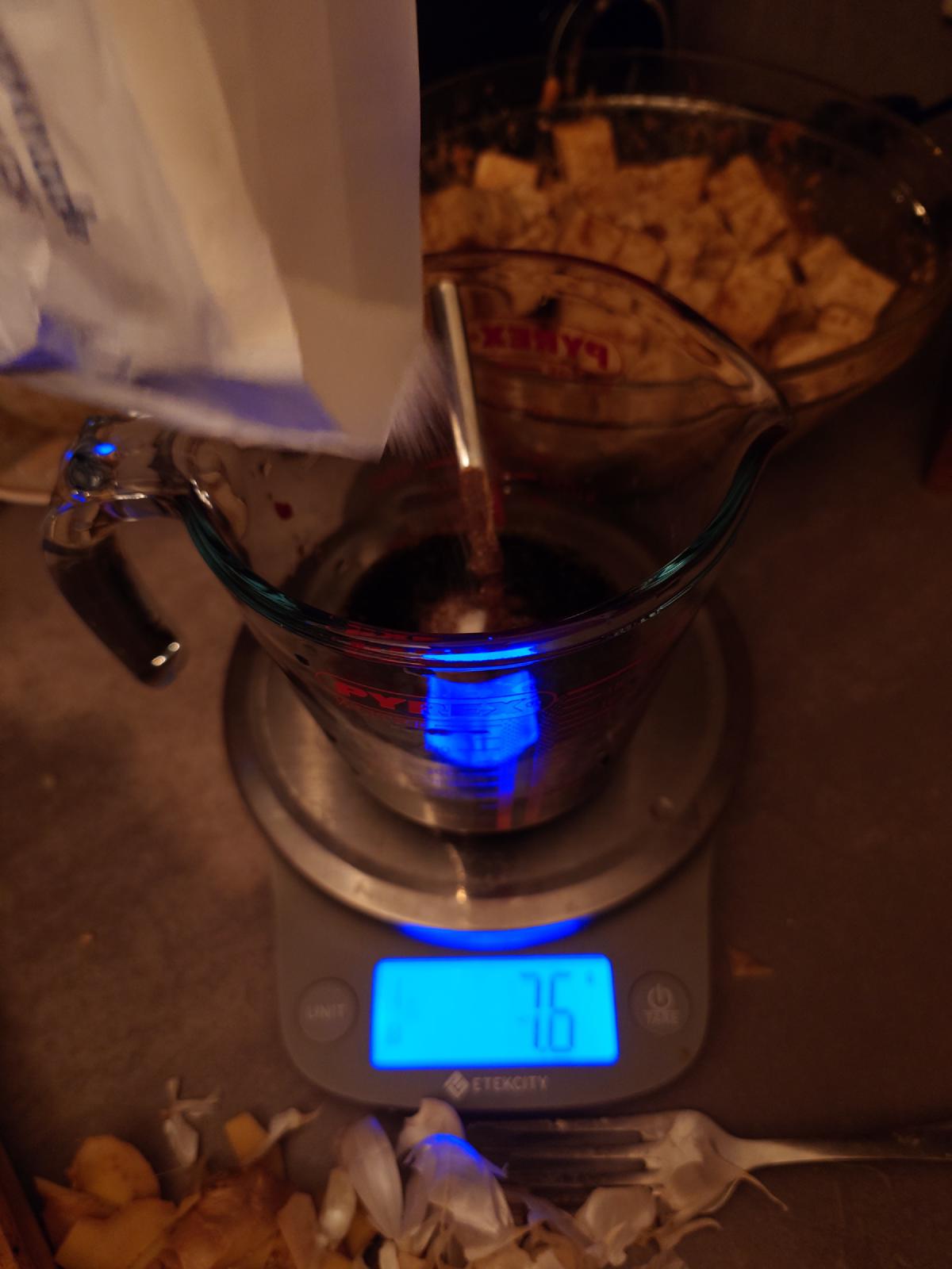 Sugar poured from the bag, the scale reading 7.6