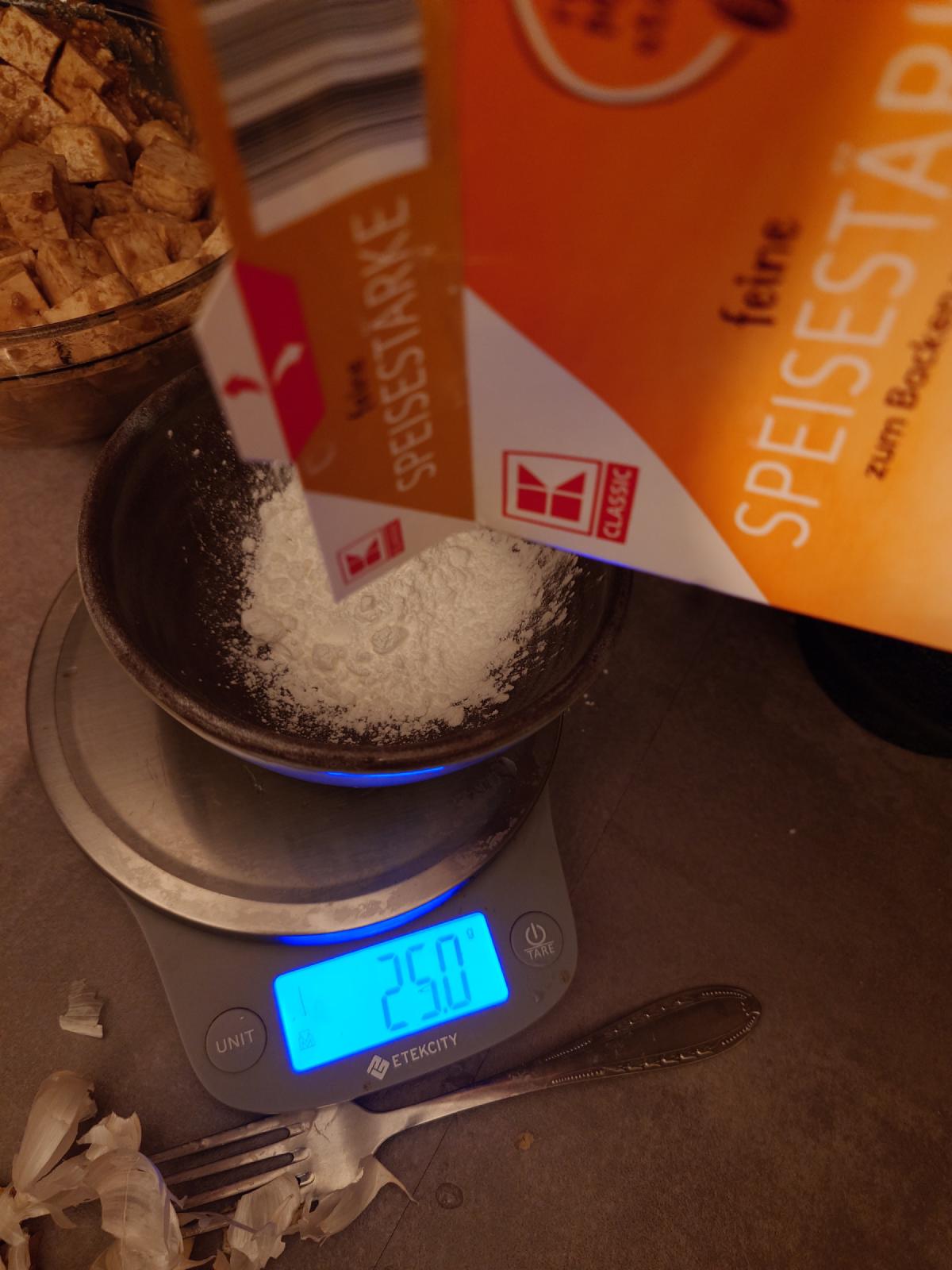 Cornstarch in a small bowl on the scale reading 25.0
