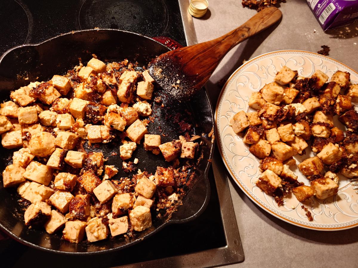 The pan floor showing stuck browned patches between the cubes