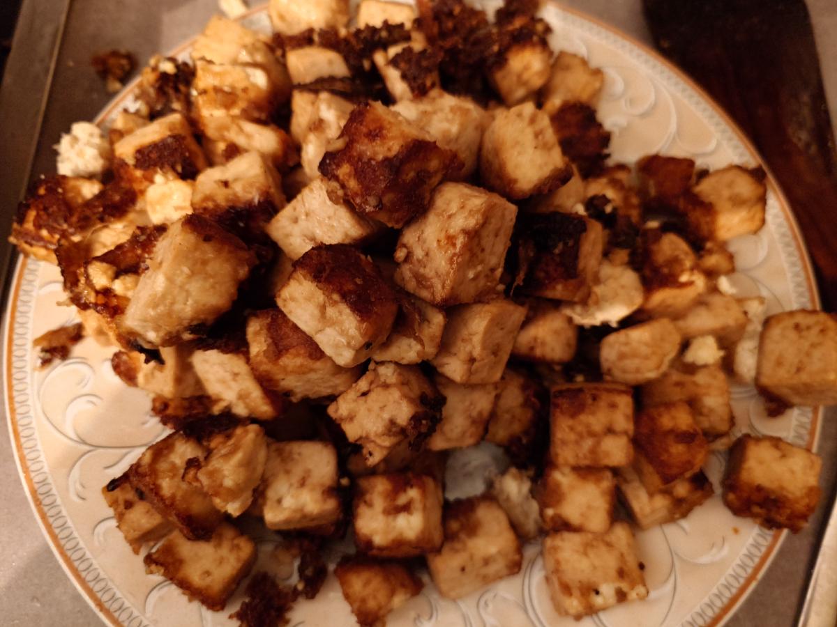 Both batches of fried tofu piled on one plate