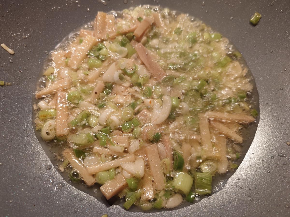 Sliced garlic added, everything frying hard