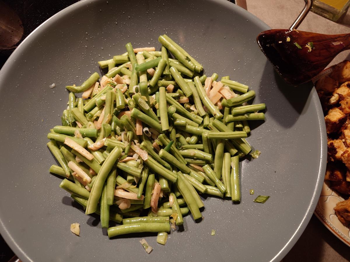 The beans tipped into the wok on top of the aromatics