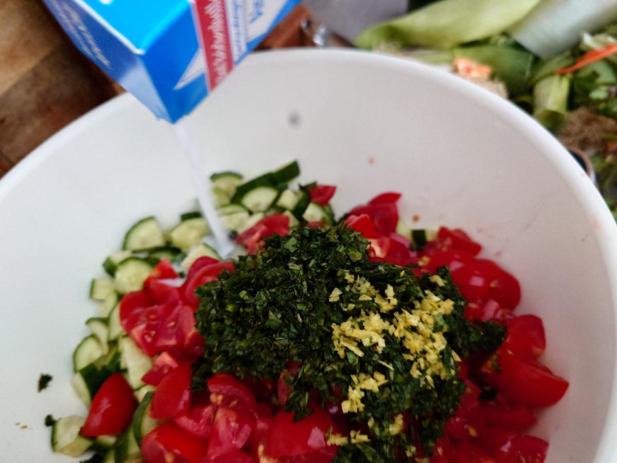 Salt poured from the blue box onto the herbs and zest in the bowl