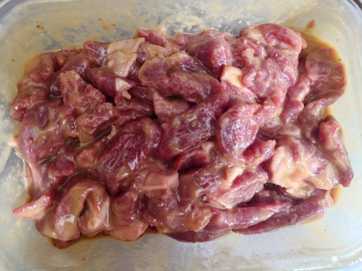 Beef evenly coated after a shake in the sealed container