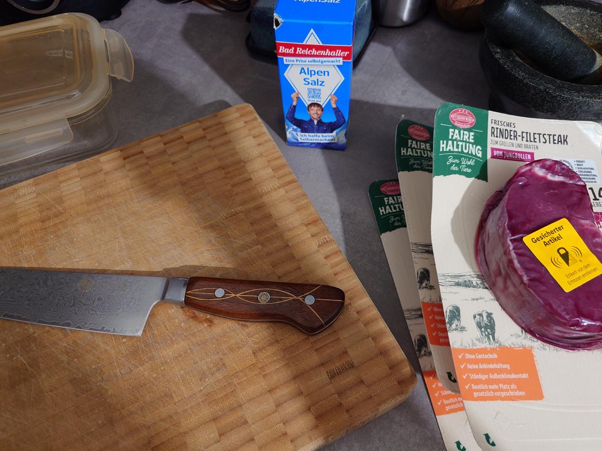 Fillet steaks and the salt box next to the board