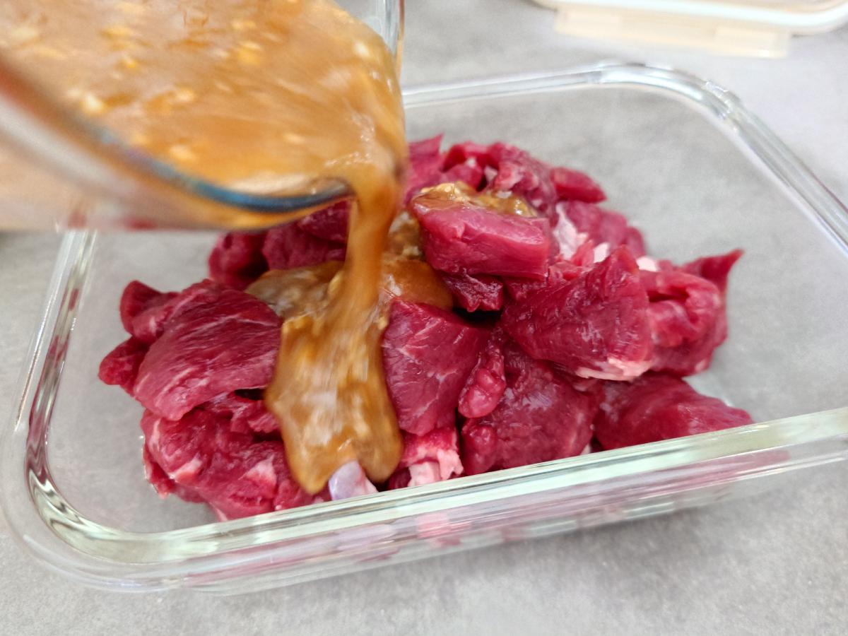 Marinade poured over the sliced beef