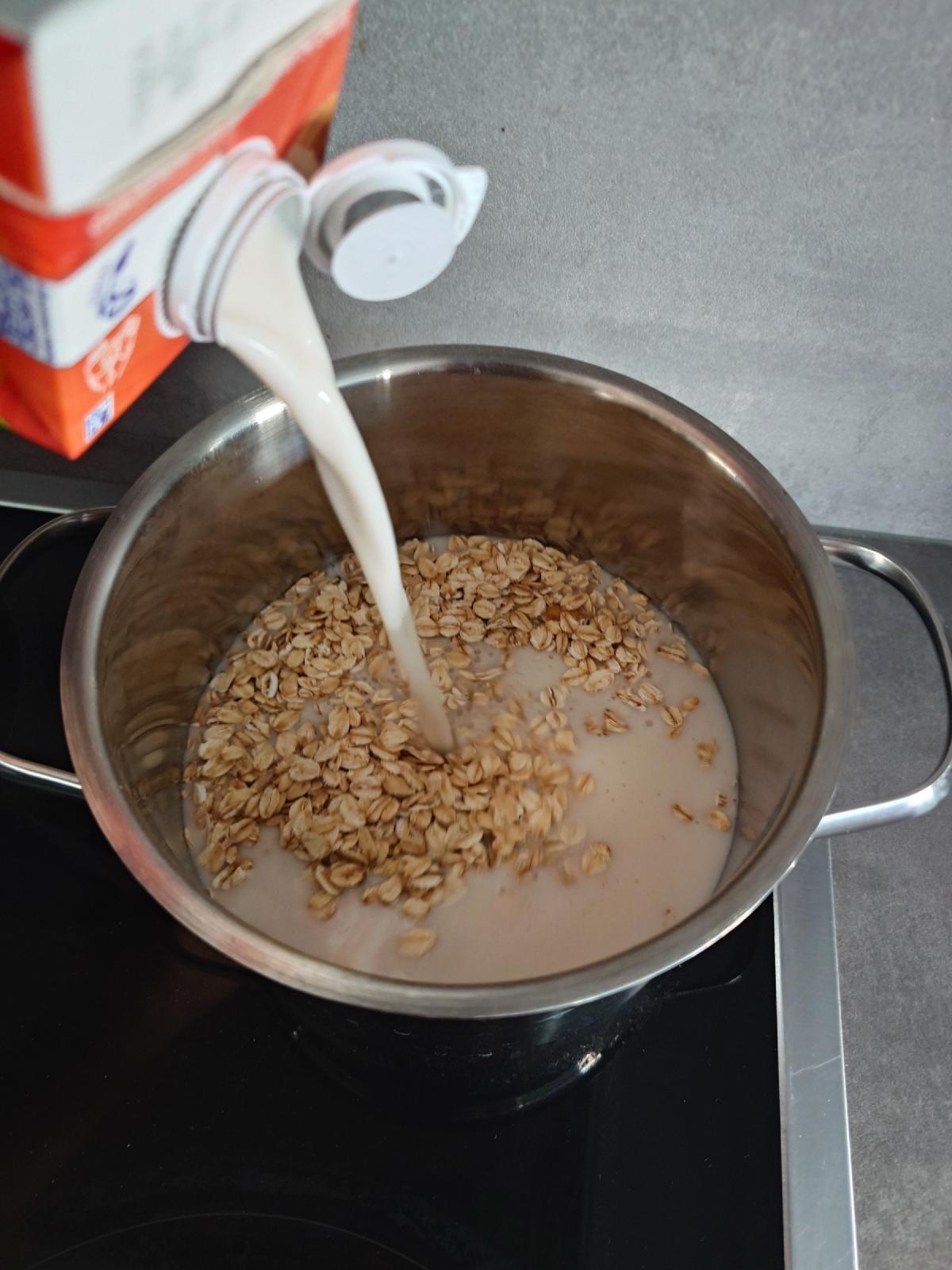 Milk poured from the carton over the dry oats