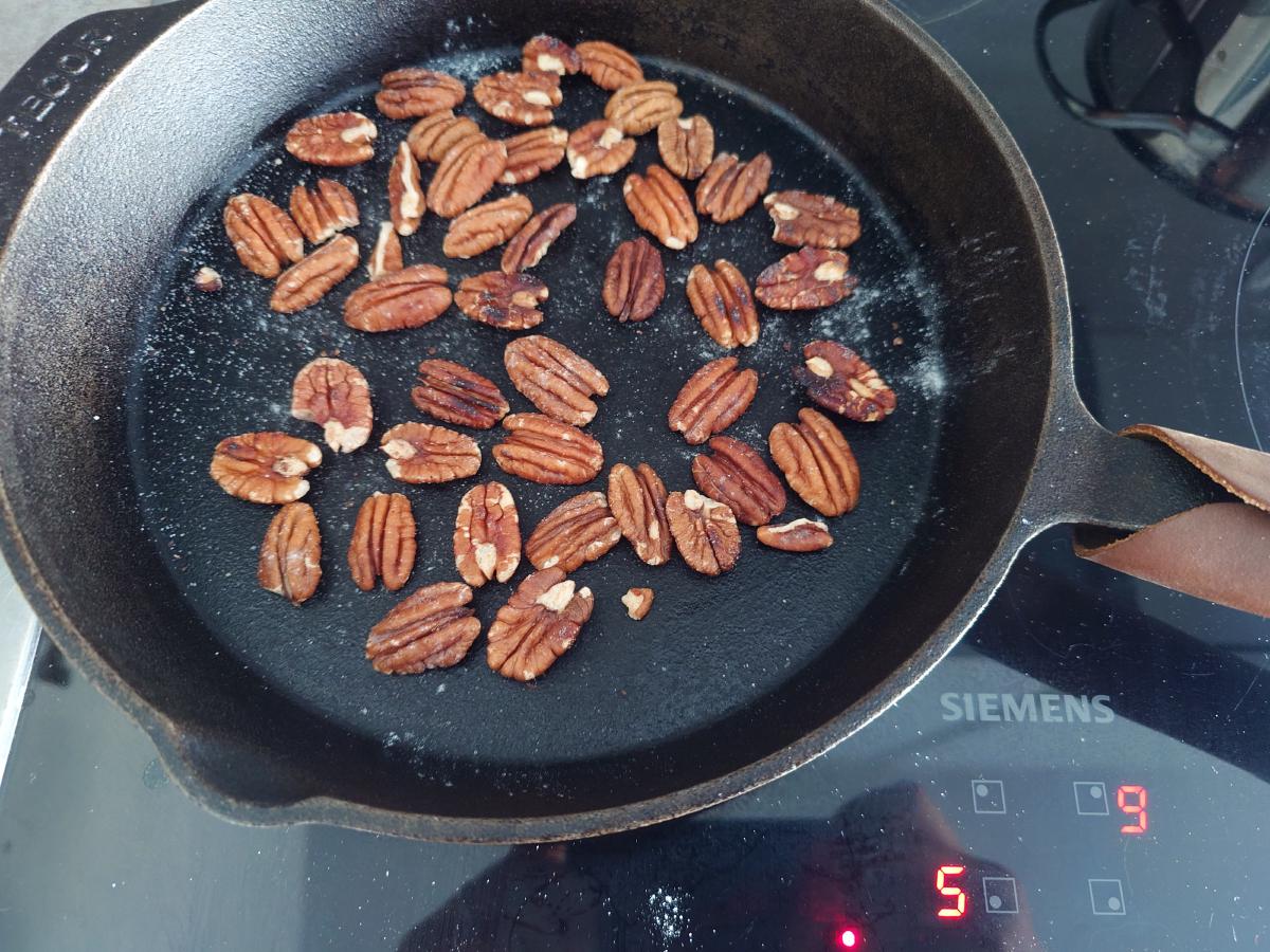 The same pecans four minutes later, darkened and glossy
