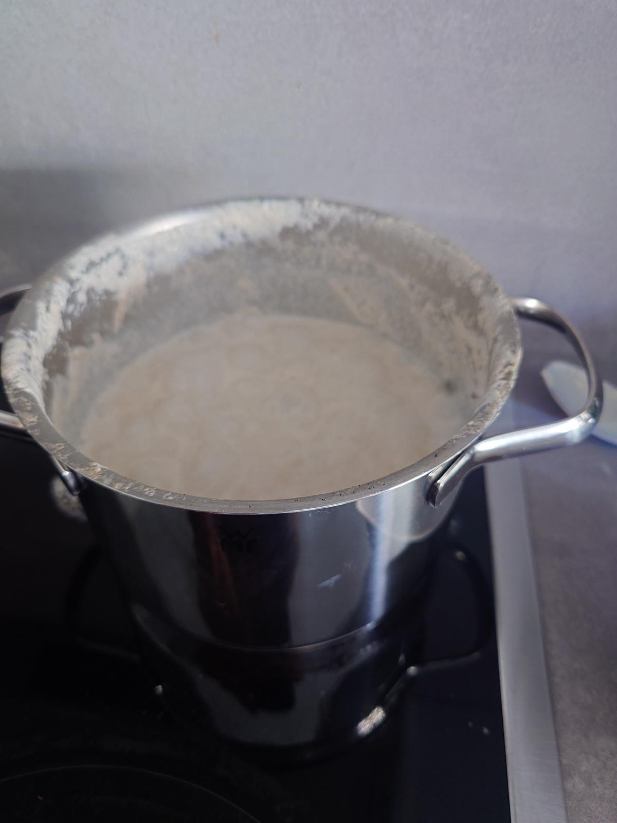 The pot with the oats thickened, a dried milk line up the sides
