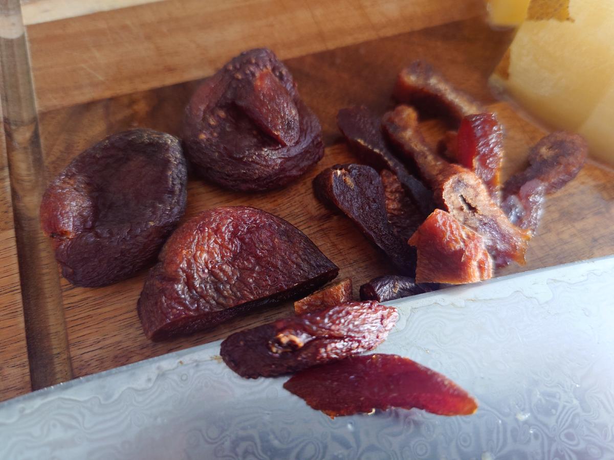 Dried apricots on the board, some left whole, the rest sliced into strips