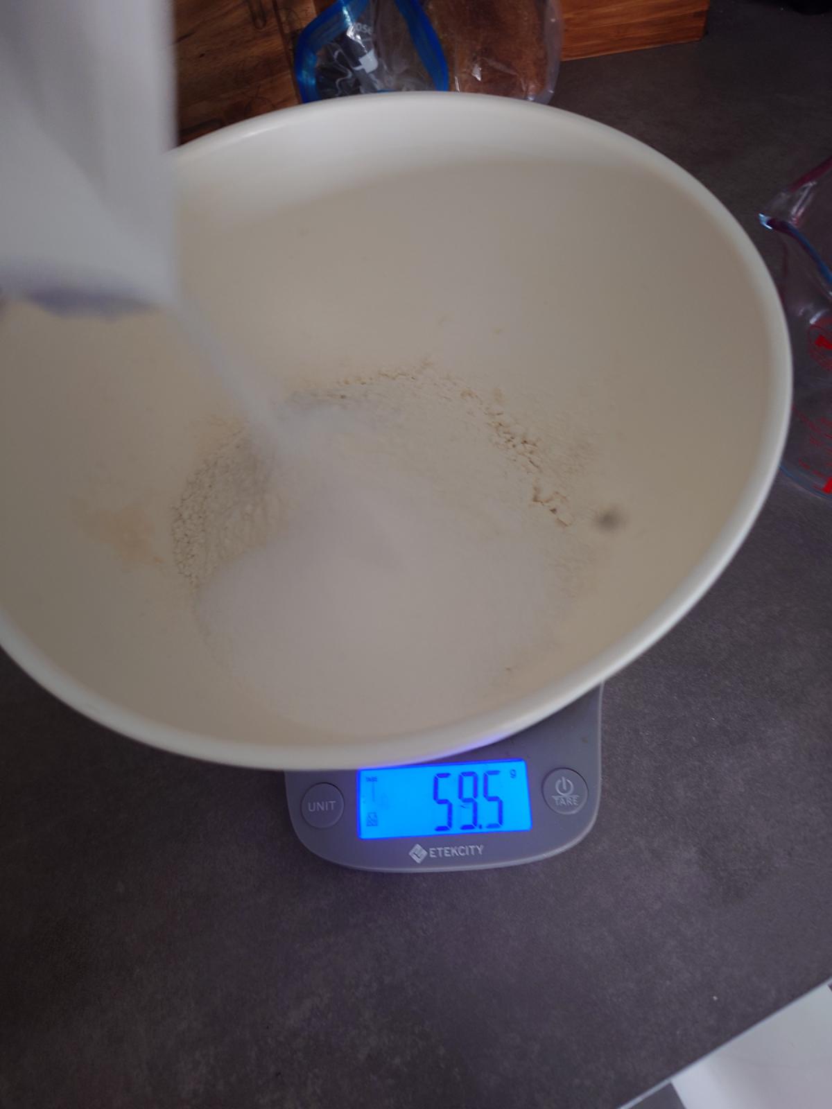 Sugar tipped in on top of the flour, 59.5 g on the scale