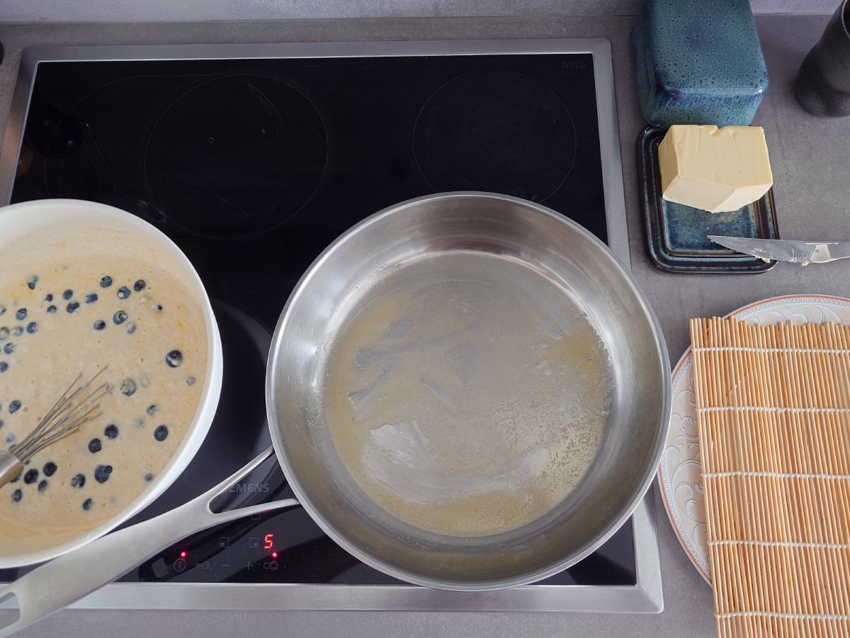 Butter melted flat across the steel pan, dial at 5, batter bowl alongside