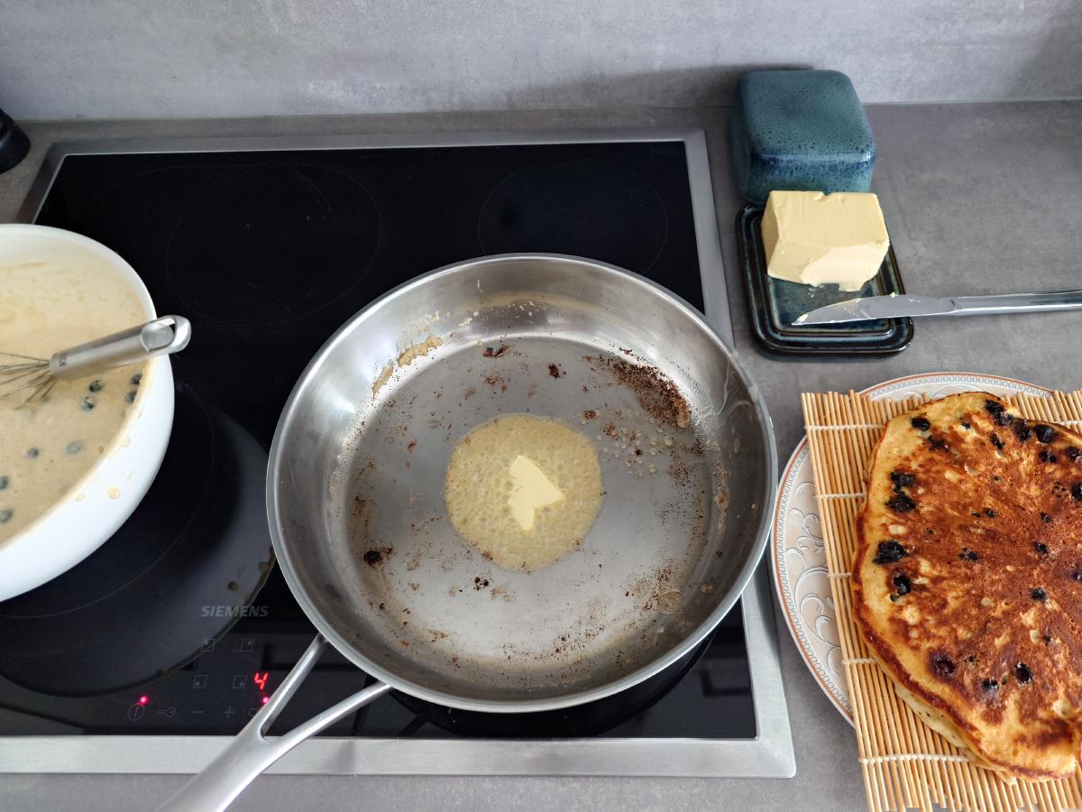 Fresh butter melting in the pan at 4, the first pancake resting on the bamboo mat