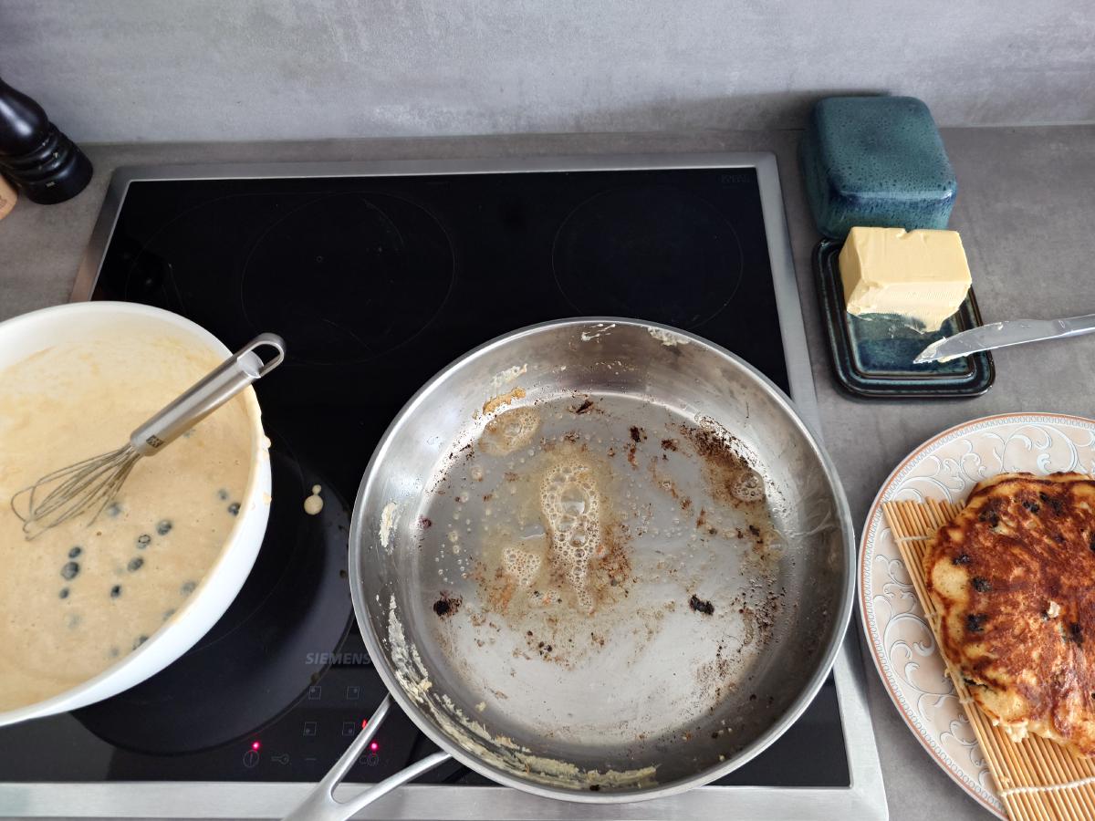 The wiped pan with fresh butter bubbling at 4