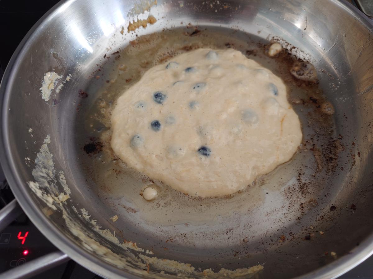 Third pancake poured, small and thick