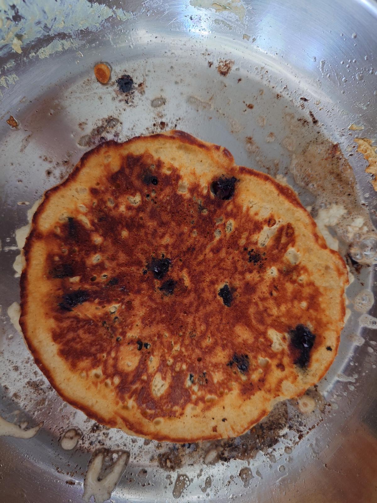 Third pancake flipped, an even golden brown