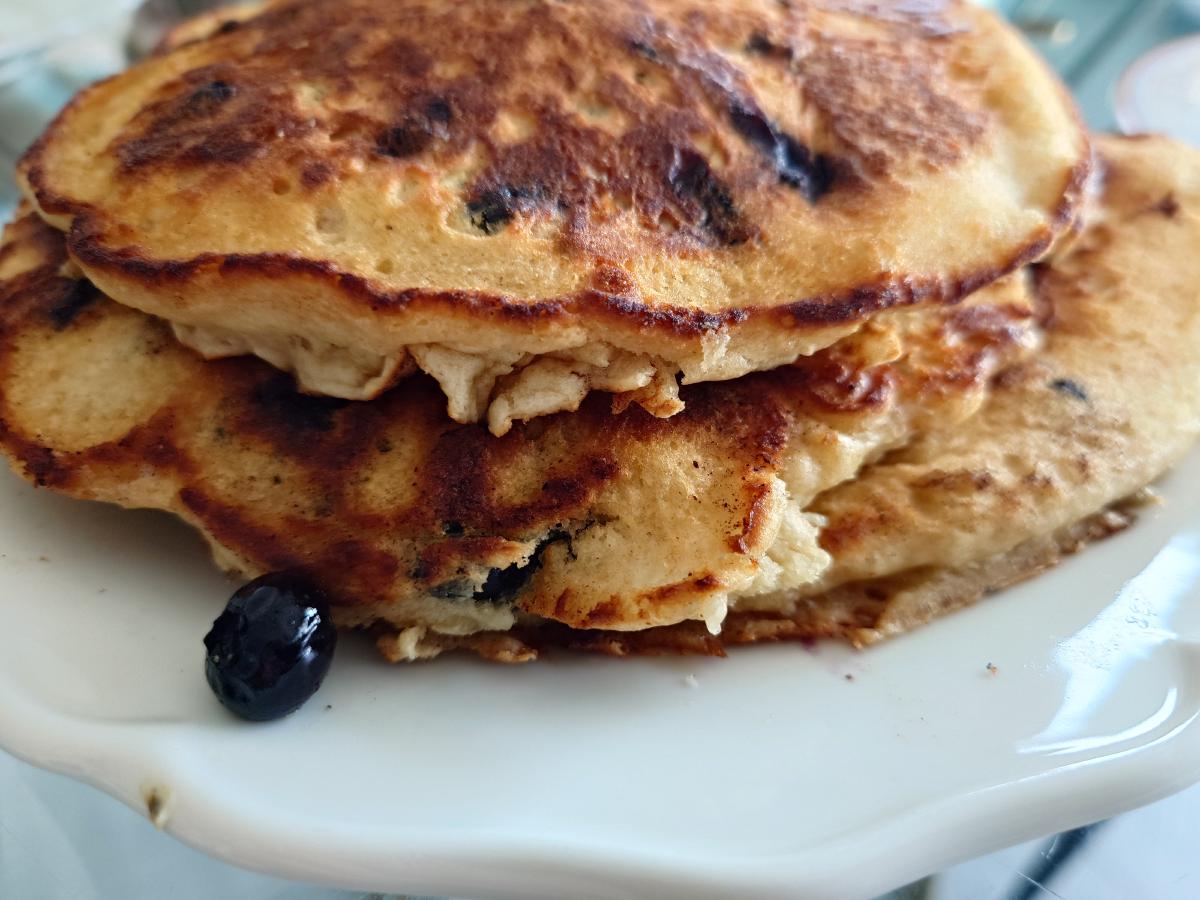 The stack of blueberry pancakes on the plate