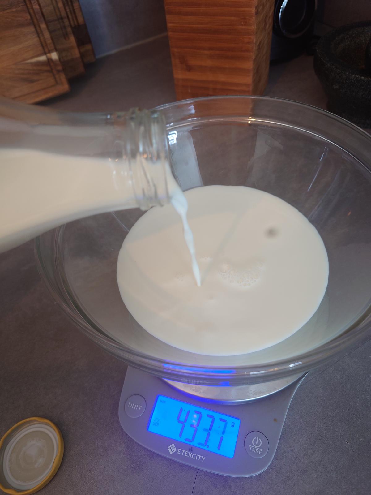 Milk poured into the glass bowl on the scale