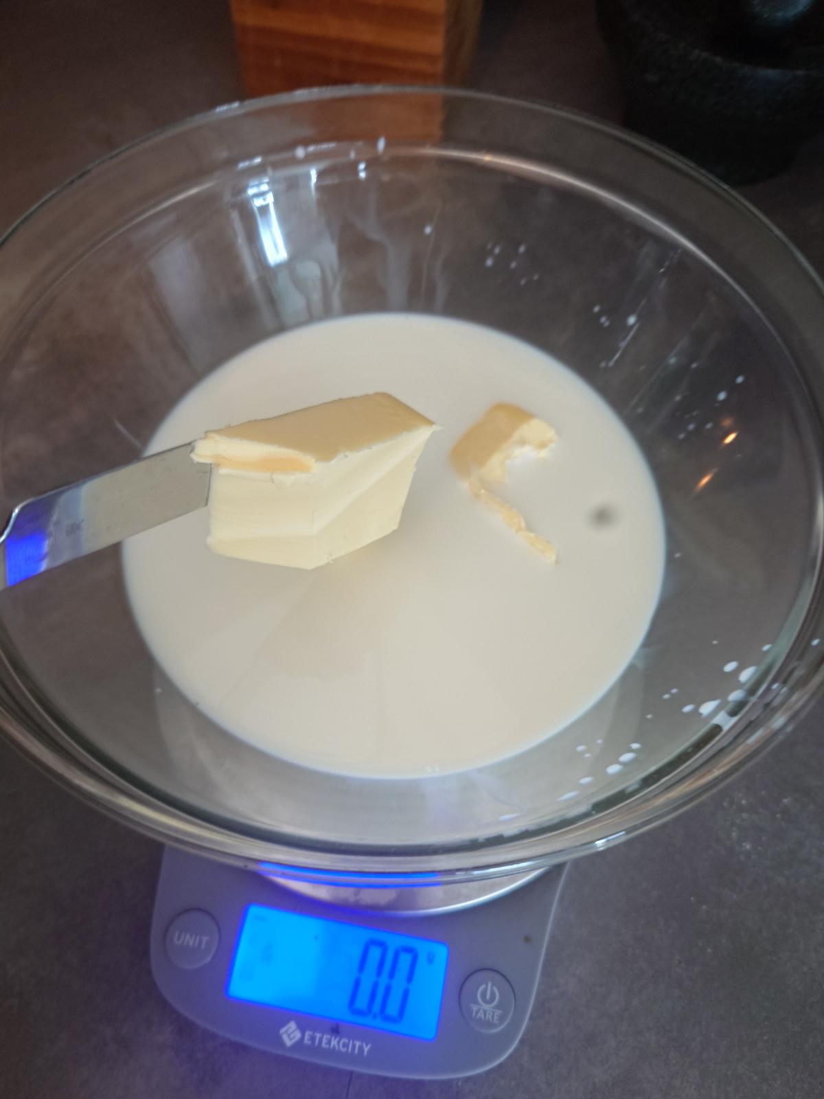 Butter added to the milk on the knife