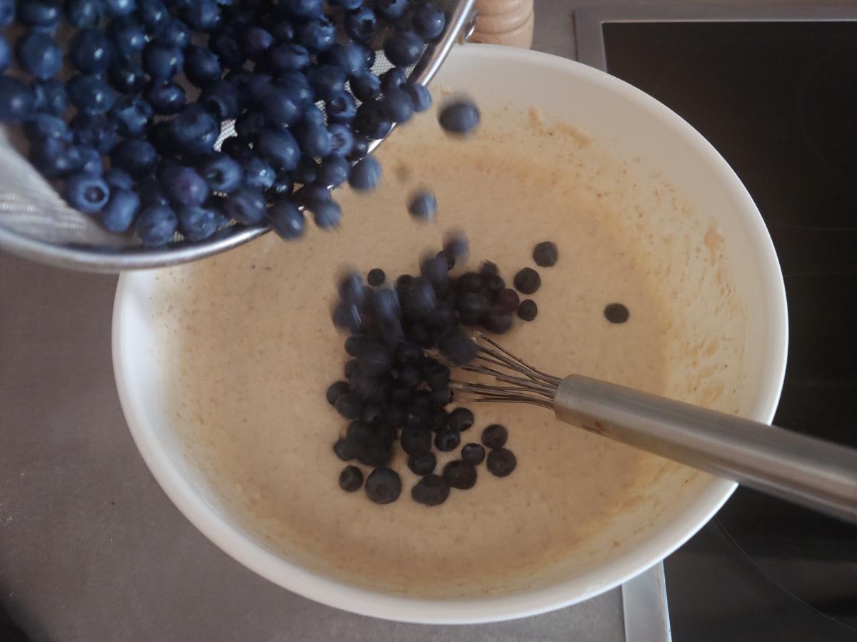 Blueberries poured into the batter