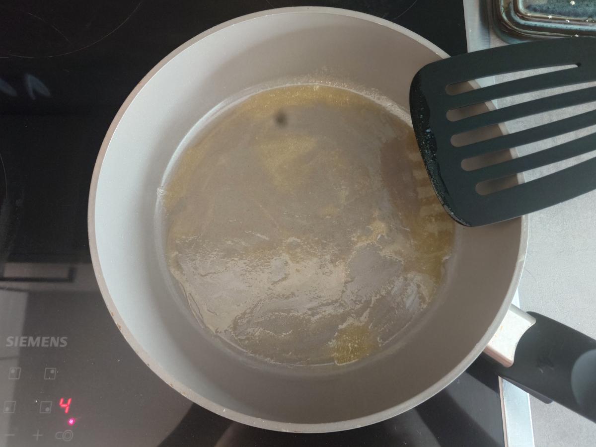 Butter melted and spread around the pan