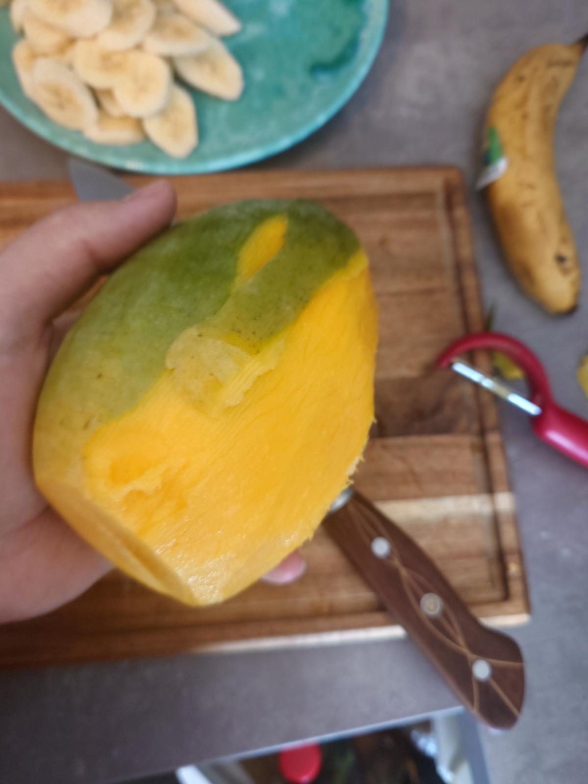 Mango peeled in hand