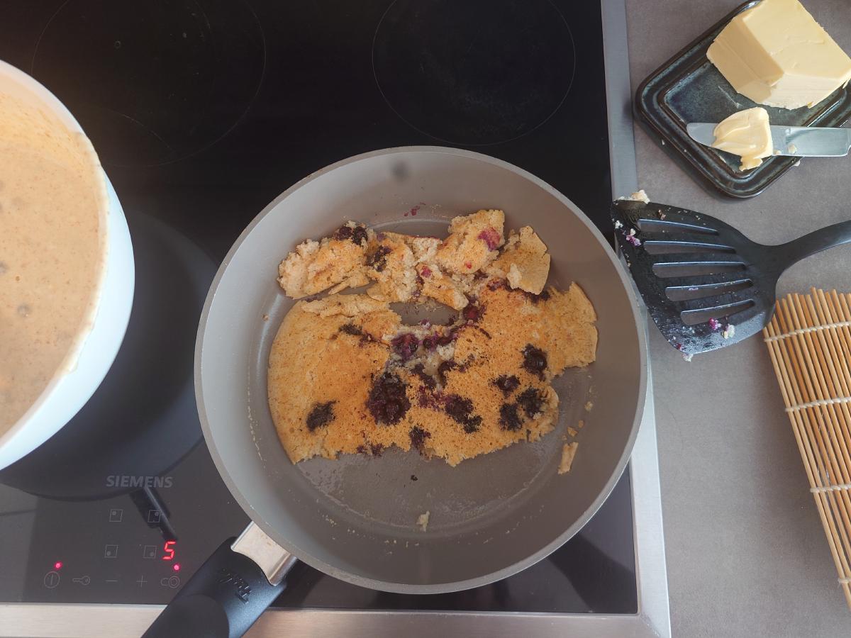 The failed flip, pancake in pieces in the pan